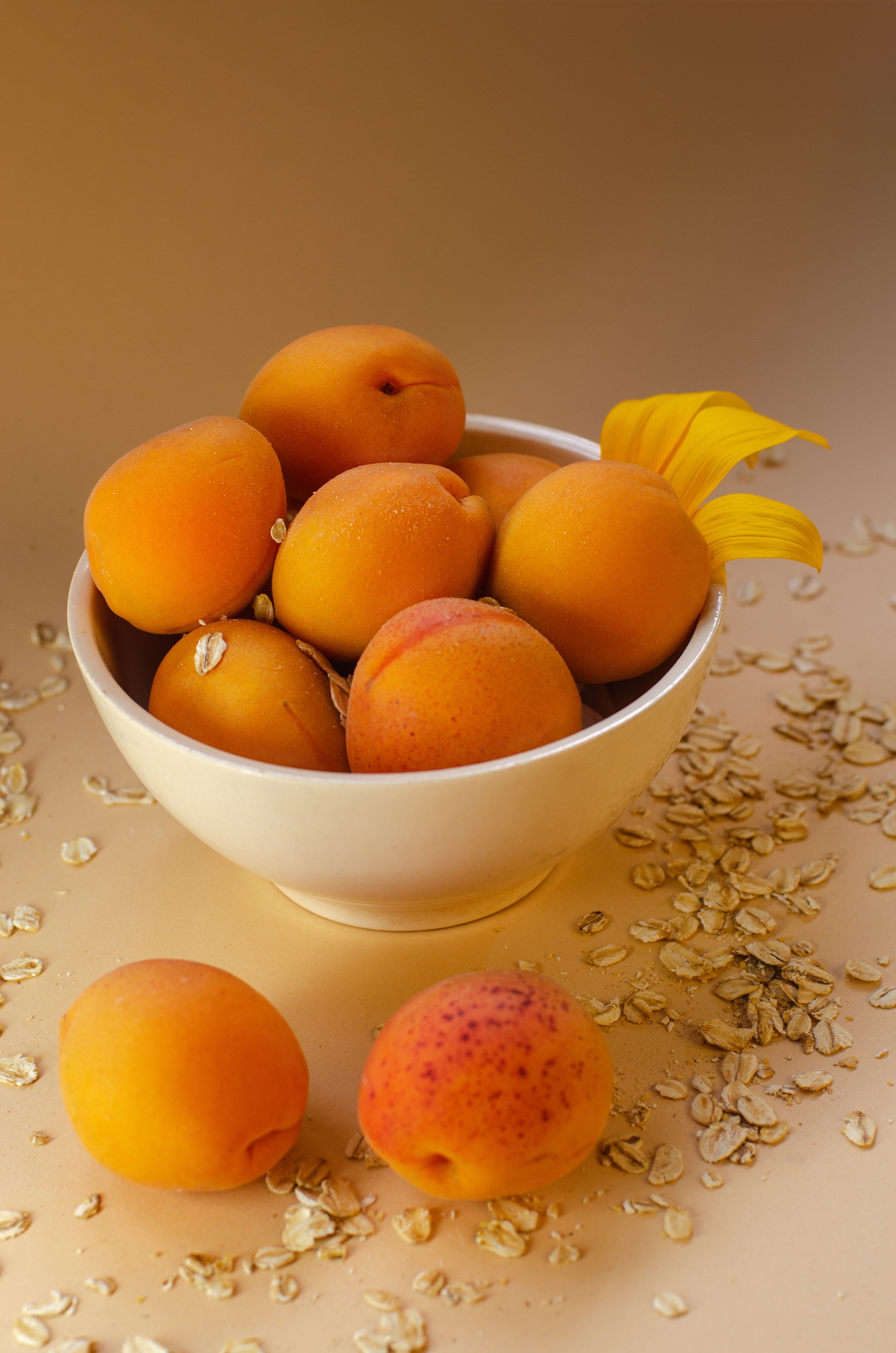 fresh-apricots-on-a-white-table-strewn-with-oatmea-2023-11-27-05-14-18-utc